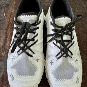 On Running White and Black Athletic Shoes with Distinctive Design